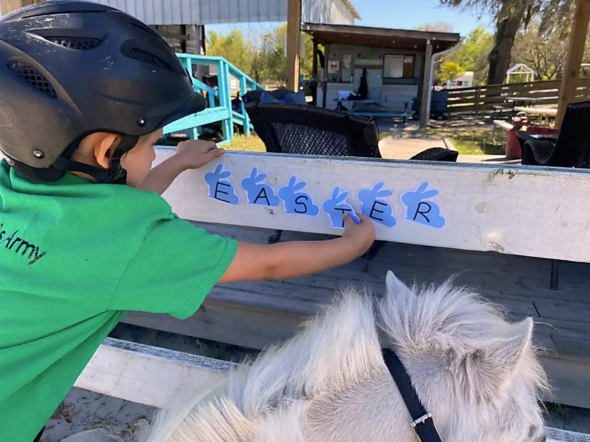 Child reading to a horse